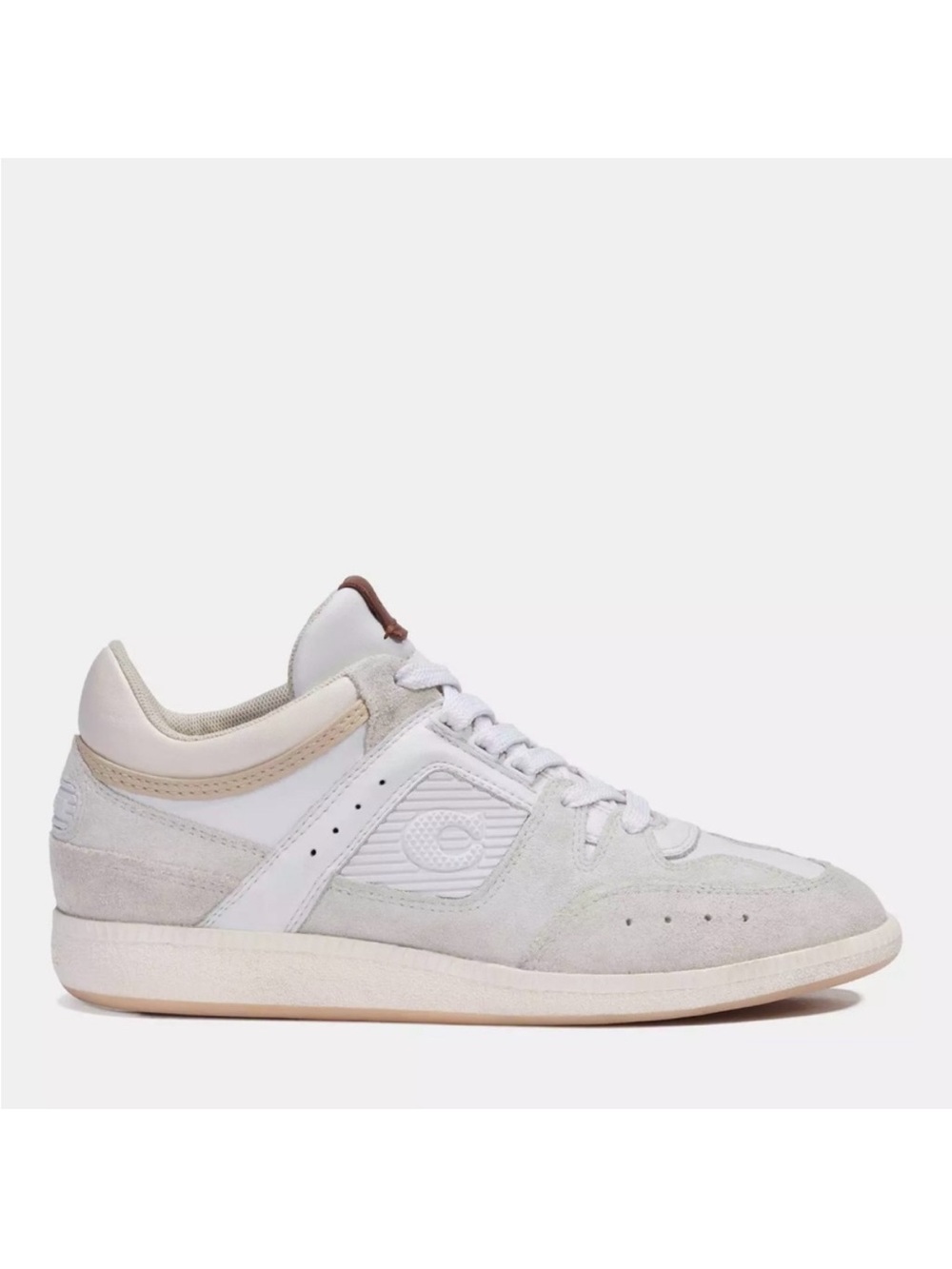 Coach CitySole sneakers in a light beige and white colorway.